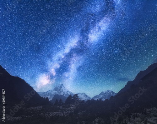 Milky Way. Amazing scene with himalayan mountains and starry sky at night in Nepal. High rocks with snowy peak and sky with stars. Beautiful Manaslu, Himalayas. Night landscape with bright milky way