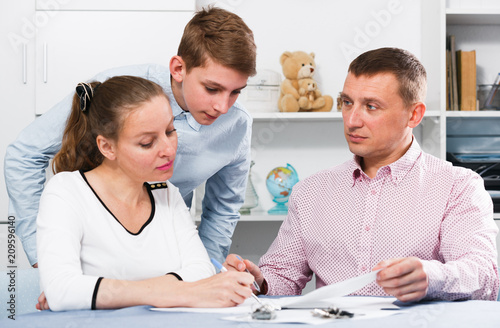 Mother and son signing documents