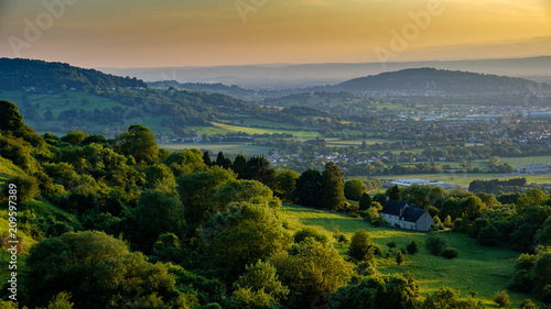 A golden sunset in summer overlooking the countryside from Crickley hill near Gloucester, Gloucestershire UK 