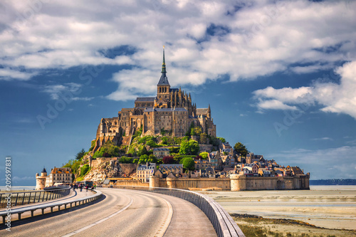 Beautiful panoramic view of famous Le Mont Saint-Michel tidal island with blue sky. Normandy, northern France