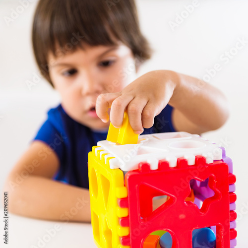 Child psychology, preschooler doing test with didactic cube