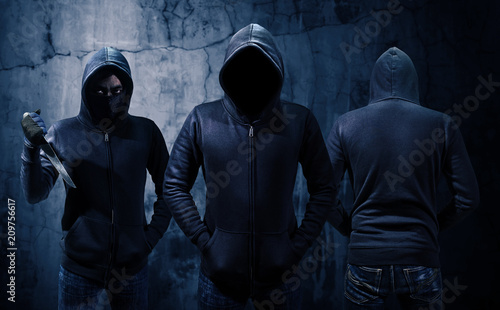 Gang of robbers or burglars dressed in black