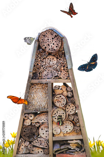 Insect hotel with flying butterflies