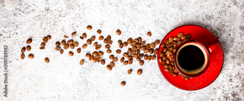 Coffee Beans Fragrant in the Red Cup on the Gray Background. Top View. Copy space for Text.Banner