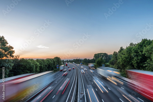 Sunset view heavy traffic moving at speed on UK motorway in England