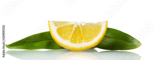 Small juicy piece of lemon with leaves isolated on white