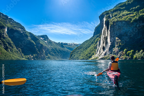 man kayaking along the fjord
