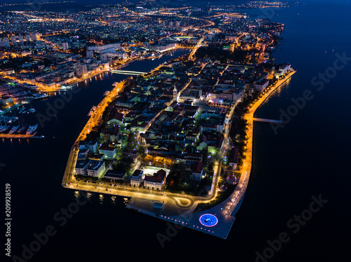 Aerial view of Zadar peninsula at night with beautiful lights and Adriatic sea, Croatia, drone