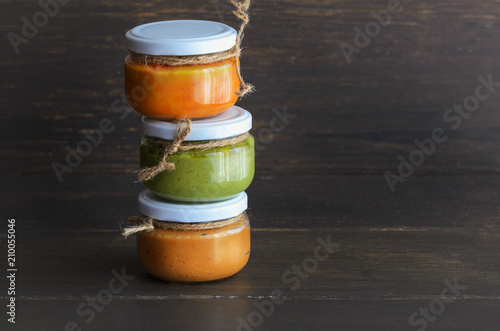 Several types of typical Canary Islands sauces in glass jar: Mojo picon, mojo verde made and almogrote are popular souvenirs of the fun holiday experience. Copy space