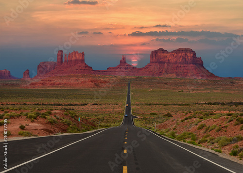 Scenic highway in Monument Valley Tribal Park in Arizona-Utah border, U.S.A. at sunset.