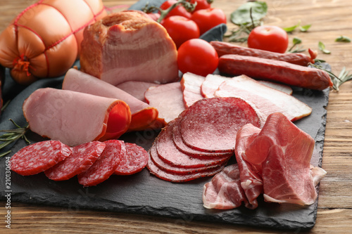 Assortment of delicious deli meats on slate plate