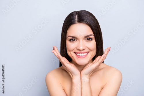Portrait of gorgeous toothy woman presenting perfect smooth soft idyllic face skin isolated on grey background. Detox botox collagen vitamins minerals wellness wellbeing enhancement concept