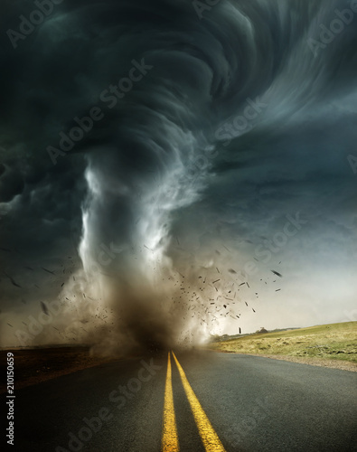 A powerful supercell storm producing a destructive tornado touching down on an isolated country road. Mixed media illustration.