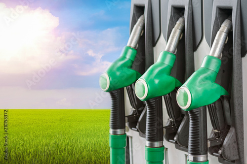 A number of fuel dispensers in the filling column against the background of a green field. Biodiesel, biofuel ecology