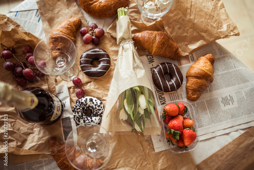 Still life, food and drink concept. Breakfast with croissants, fruits and champagne. Selective focus, top view flat lay