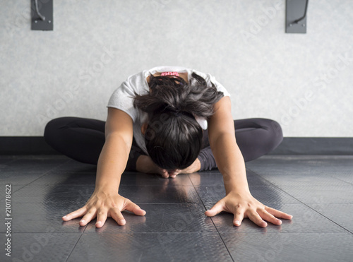 Yoga dancer Hip stretch in butterfly position reaching forward head to feet