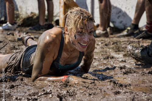 Woman crawling in mud