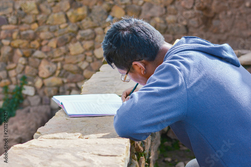 Illiterate native american man learning to write in the countryside.