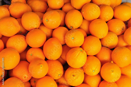 Closeup oranges in bulk for sale in fruit stall 