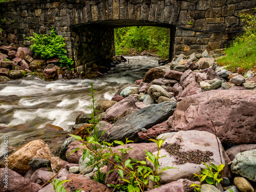 The stone bridge that allows passage over Snyder Creek in Glacier National Park