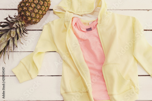 Yellow Hoodie And Shirt, Pineapple. White Old Wooden Background