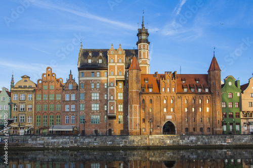 Ancient colored houses on the promenade of the river at dawn in Gdansk