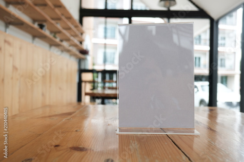 white label in cafe. display stand for acrylic tent card in coffee shop. mockup menu frame on table in restaurant. space for text