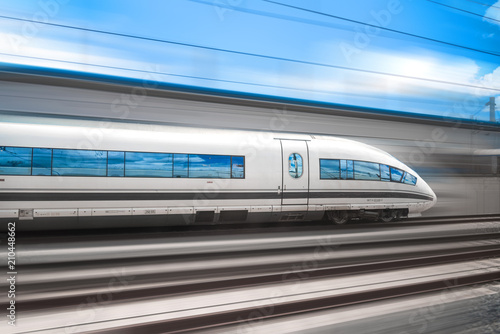 The high speed train rushes through the city by rail