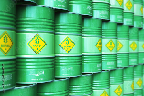 Group of rows of green stacked biofuel drums in storage warehouse