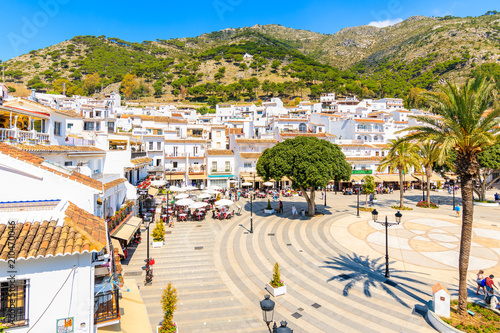 MIJAS VILLAGE, SPAIN - MAY 9, 2018: Main square with houses in picturesque white village of Mijas, Andalusia. Southern Spain is famous for mountain villages with white architecture.