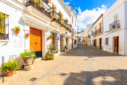 Narrow street with houses in white Andalusian village with typical Spanish architecture, Zahara de la Sierra, Spain