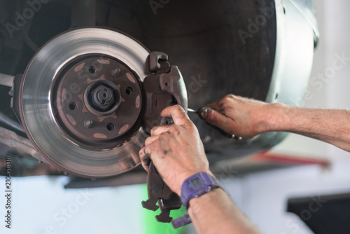 Close up of car mechanic repairing brake pads
