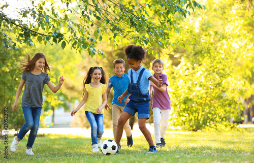 Cute little children playing with ball outdoors on sunny day