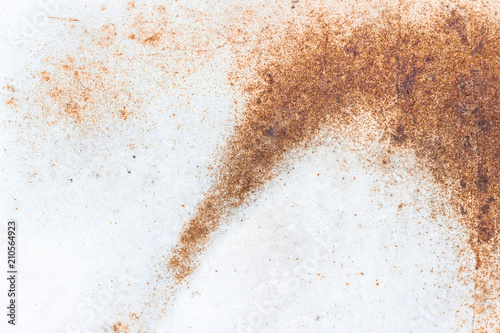 A close-up of rust on a white metal plate. Abstract background texture