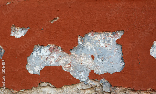 Damaged wall with red painted render background