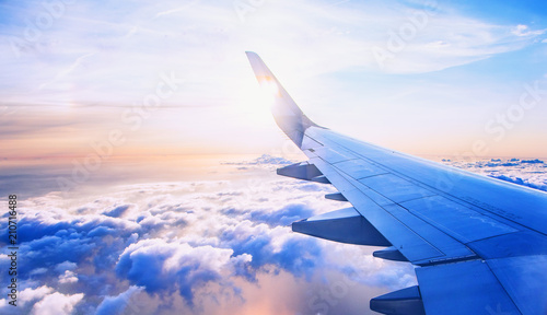 flying and traveling, view from airplane window on the wing on sunset time