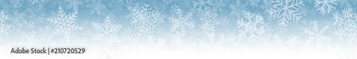 Christmas horizontal seamless banner of many layers of snowflakes of different shapes, sizes and transparency. On gradient background from light blue to white.