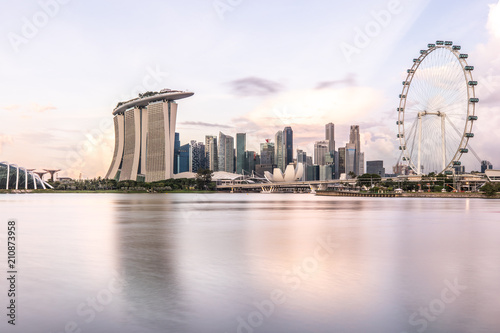 Sun rising over the downtown skyline of Singapore as viewed from across the water from The Garden East. Singapore.