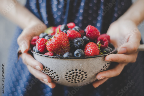 Organic fresh berries. Hands holding fresh juicy berries, closeup