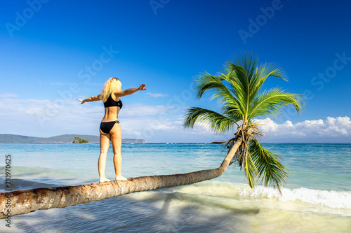 girl making steps on the palm tree