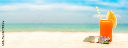 Refreshing fruit punch drink in summer white sand beach banner background