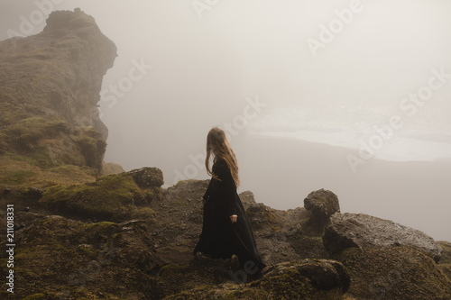 Woman in black dress in the fog in iceland