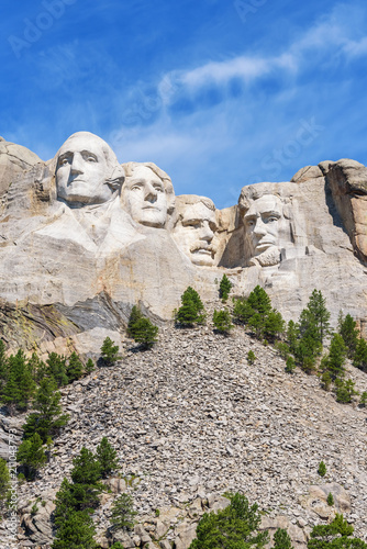 Presidential sculpture at Mount Rushmore national memorial, USA. Blue sky background. Vertical layout.