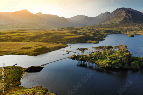 Twelve Pines Island, standing on a gorgeous background formed by the sharp peaks of a mountain range called Twelve Bens, County Galway, Ireland
