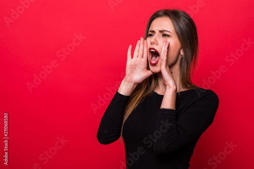 Portrait woman shouting over red background