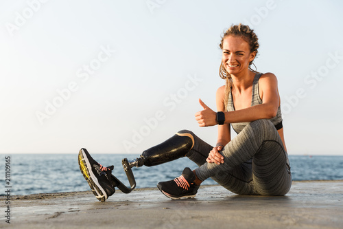 Smiling disabled athlete woman with prosthetic leg