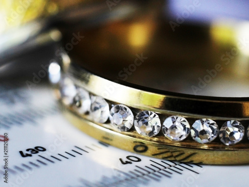 Gold ring with diamonds and a measuring instrument, macro