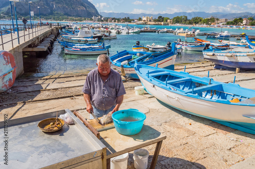 Mondello, Sicily, Europe-10/06 / 2018.Sililian fisherman emptying a fresh fish in the port of Mondello