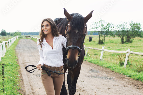 Young woman rider and her beautiful horse