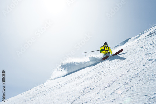 The total length of skiing on fresh snow powder. Professional skier outside the track on a sunny day